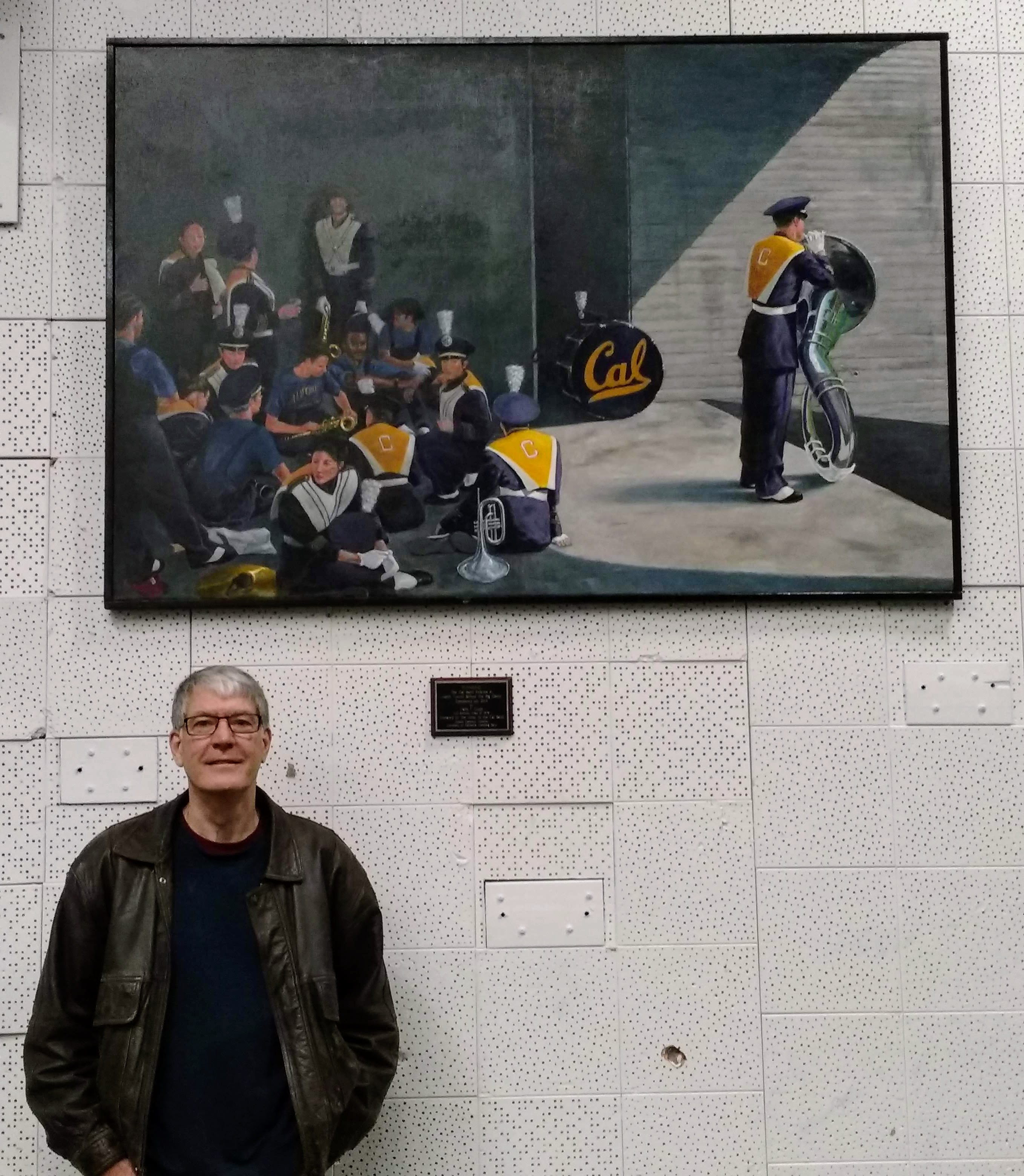 The artist with the installed painting.