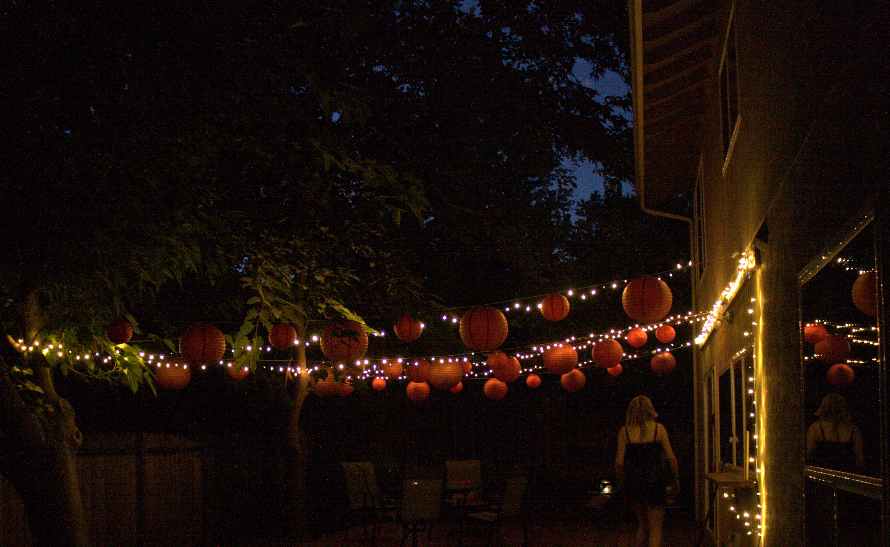 Backyard Patio with Paper Lanterns at Night